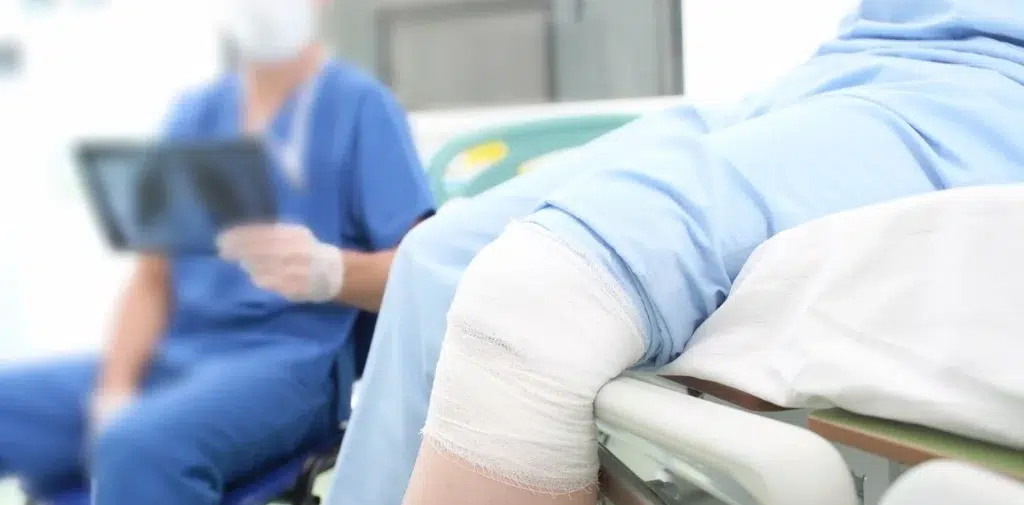 A patient with bandage tied to her knee