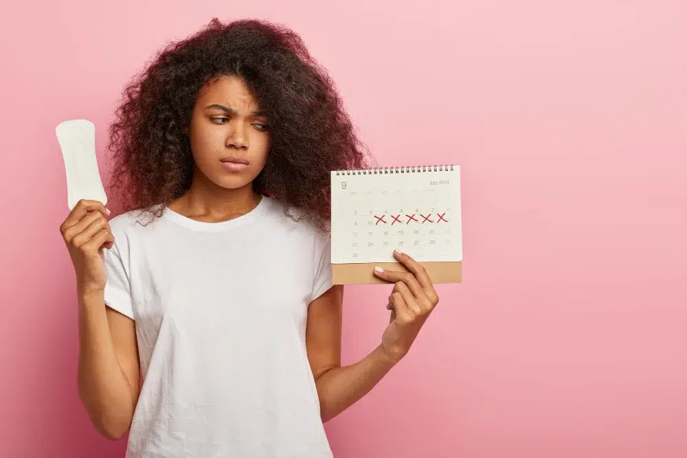 a young girl holding a pad and a calendar