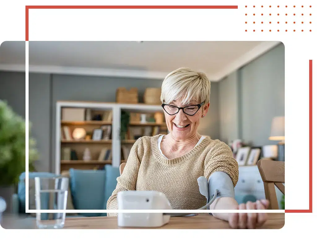 An elderly woman checking her blood pressure