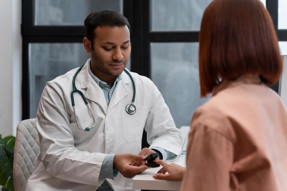 Doctor using a pulse oximeter to check a patient’s oxygen levels during a medical consultation in a clinic.