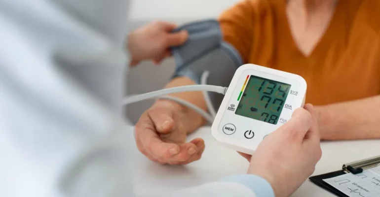 A doctor checking the blood pressure of a patient