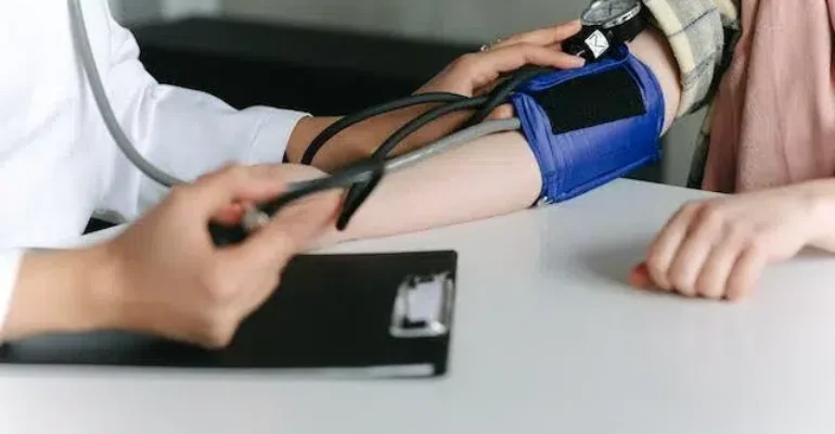 A doctor checking the blood pressure of a patient